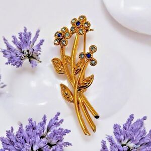 Vintage Movitex Goldtone Flower Brooch 1.75" Blue Rhinestone Floral Pin